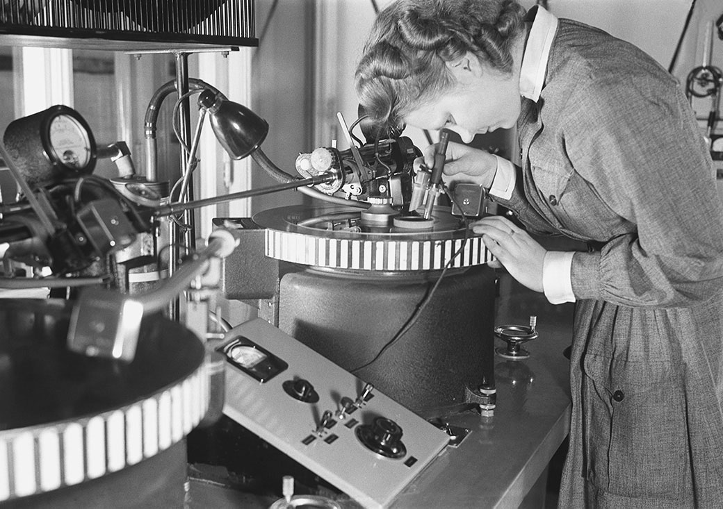A technician examining a machine at close range - focused work that depends on patience, calibration and care.